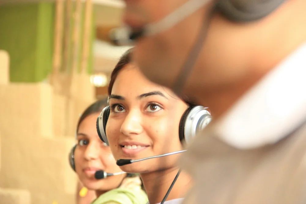 Customer service professionals working with headsets in an office